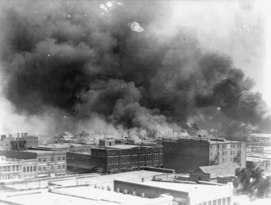 In this 1921 image provided by the Library of Congress, smoke billows over Tulsa, Okla. For decades, when it was discussed at all, the killing of hundreds of people in a prosperous black business district in 1921 was referred to as the Tulsa race riot. Under new standards developed by teachers for approaching the topic, students are encouraged to consider the differences between labeling it a “massacre” instead of a “riot,” as it is still commemorated in state laws. (Alvin C. Krupnick Co./Library of Congress via AP)