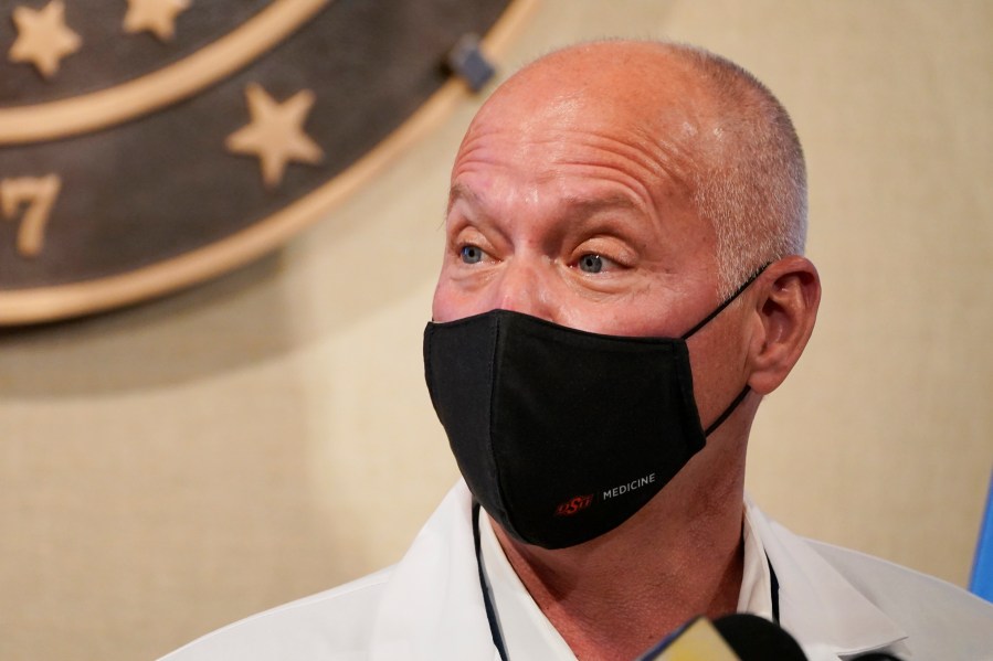 In this Monday, Nov. 16, 2020, photo, interim Oklahoma Health Commissioner Dr. Lance Frye speaks during a news conference in Oklahoma City. Concerning the coronavirus surge in Oklahoma, Frye said in a statement "We must remember that each count, each case and each infection is a life." Frye again urged residents to wear masks, frequently wash their hands and stay away from others. (AP Photo/Sue Ogrocki)