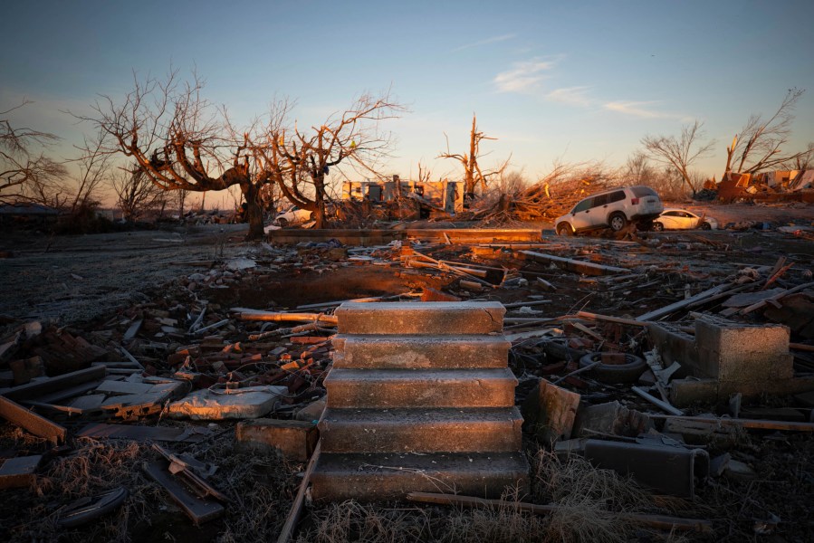 The front steps of a house are all that remains after a tornado in Dawson Springs, Ky., Sunday, Dec. 12, 2021. A monstrous tornado, carving a track that could rival the longest on record, ripped across the middle of the U.S. on Friday. (AP Photo/Michael Clubb)