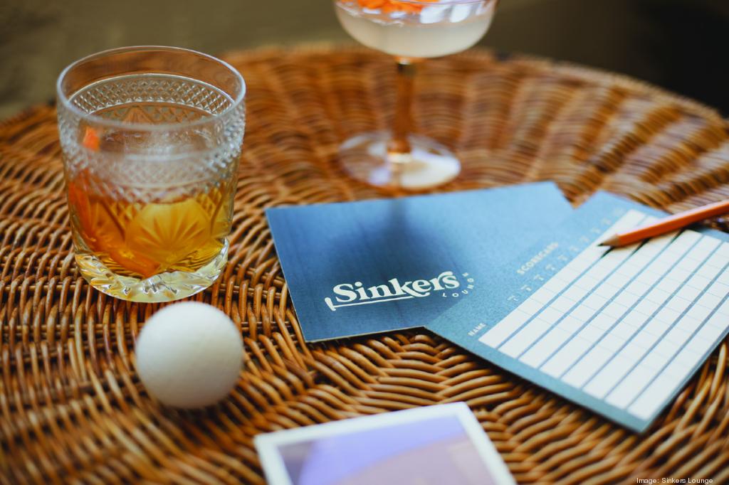 Picture of golf ball, cocktail and score cards